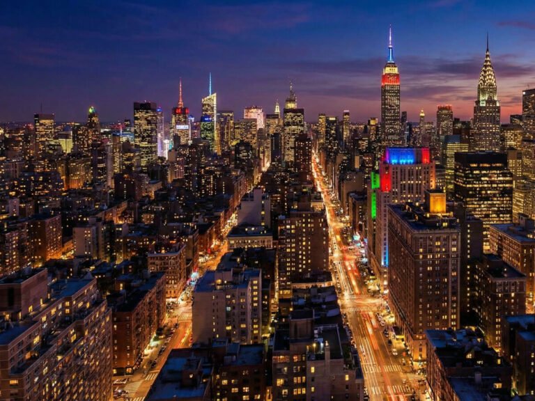 Aerial view of the vibrant New York City skyline at night, showing illuminated Midtown landmarks near many of the best hotels in New York.